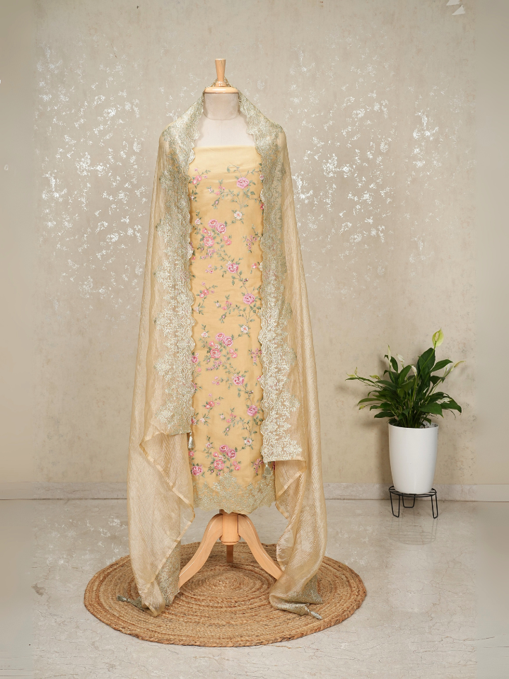 Beige organza shirt with heavy thread embroidery and zari embroidery on hem and dupatta border with crepe bottom
