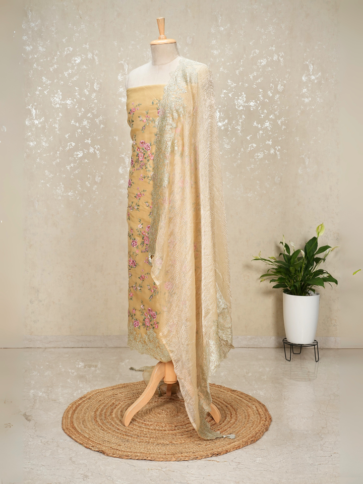 Beige organza shirt with heavy thread embroidery and zari embroidery on hem and dupatta border with crepe bottom